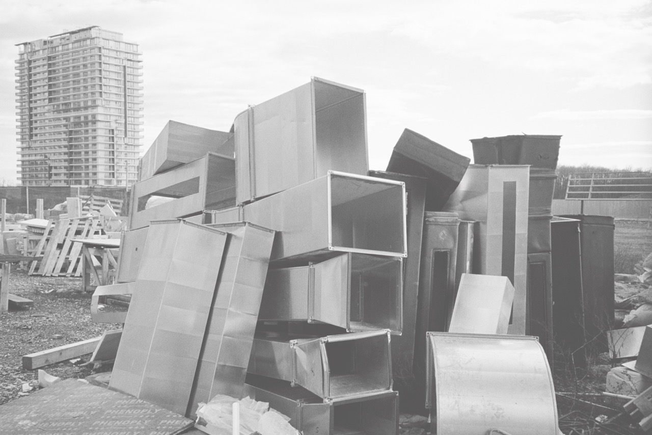 Rectangular ducts stored behind a fence